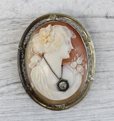 HERE ARE THE DETAILS YOU NEEDN6012Art Deco 14K White Gold Carved Shell Cameo Brooch Filigree Pendant Pretty LadyBEAUTIFUL LADY W/ FLOWERS, NECKLACE WITH CRYSTAL. HAND CARVED SHELL CAMEO. FINEST DETAIL AMAZING BROOCH PIN WONDERFUL HIGHEST QUALITY. JUST PART OF MY MOST RECENT ESTATE FINDS! FOLLOW ME TO SEE THEM ALL! Metal Purity: Metal: 14K White GoldMaterial: Carved Shell CameoForm: Brooch Filigree Pendant Pretty LadySize :1 7/8 x 1 3/8"Age: Art DecoWeight (Grams): 11.9IT IS IN VERY FINE ESTATE C Hinged Ring, Cameo Jewelry, Filigree Pendant, Carved Shell, Sparkling Rings, Cameo Brooch, Gold Filigree, Pink Stone, Star Pendant