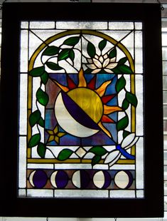 a stained glass window with an image of the sun and moon on it's side