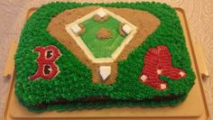 a baseball themed cake is sitting on a table