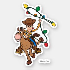 a sticker depicting a cowboy riding a horse with christmas lights on his head and holding onto the strings