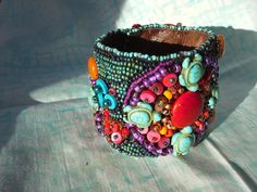 Beautiful hand beaded cuff bracelet made with an assortment of seed and other novelty beads and backed with Ultrasuede . Fits a 7"wrist with snap closures. Can be custom made to order. Unique Cuff Bracelet With Round Beads For Festivals, Handmade Cuff Bracelet With Round Beads For Festivals, Handmade Round Beads Cuff Bracelet For Festival, Unique Colorful Beaded Cuff Bracelet For Festivals, Unique Festival Cuff Bracelet With Colorful Beads, Handmade Multicolor Cuff Bracelet, Bohemian Beaded Bracelets With Bead Caps As Gift, Unique Handmade Multicolor Cuff Bracelet, Artisan Beaded Cuff Bracelet For Festivals