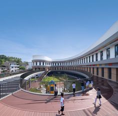 people are walking around an outdoor courtyard with stairs and circular walkways on both sides