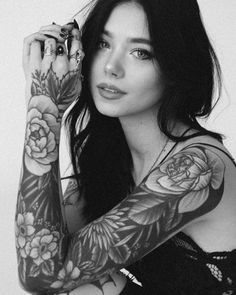 a woman with tattoos on her arms and arm