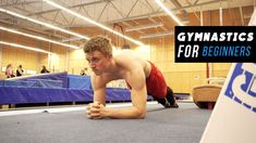 a man is doing push ups on the floor in an indoor gym with blue mats