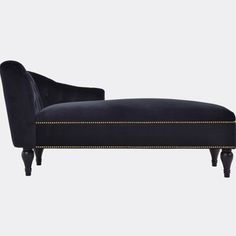 a black velvet chaise lounger with gold trimmings and nail polishing