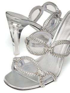 Step out in style with this luxurious silver slide sandal, a perfect blend of fashion and comfort. Crafted with a touch of Valentino Garavani's signature elegance, these chic heels offer an effortless way to elevate your everyday look. Made entirely from 100% Ovis Aries Aries, they are designed to make a style statement while ensuring your comfort. Size: 36 for the perfect fit Color: Stunning and versatile silver (S13) Composition: 100% Ovis Aries Aries for a luxurious feel Features a stylish ch Lirika Matoshi, Chic Heels, Leather Mules, Strap Design, Crystal Embellishment, Leather Jewelry, Mens Shoes Sneakers, Watch Design, Slide Sandals