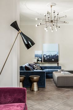 a living room filled with furniture and a chandelier