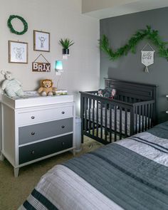 a baby's room decorated in grey and white