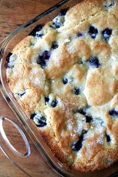 blueberry cobbler in a glass dish before and after it has been cut into pieces