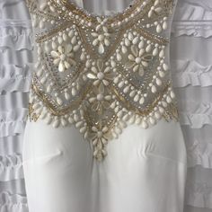 Nwt. Ivory Floor Length Gown With Gorgeous Ivory & Gold Beading And Rhinestone Detailing Over Mesh On Top/Chest Part Of Dress. High Neck. Back Detailing Is So Gorgeous. Bottom Of Dress Trails A Little. Lined. Size 2. Comes With Small Bag Of Extra Beads. Purchased This Lovely Dress For My Wedding And Ended Up Wearing Another. Few Spots (9ish) Where Rhinestones Have Fallen Off. They Appear As Black Spots In Photos. Easily Repaired. Sleeveless Embellished Wedding Dress For Prom Season, Fitted White Gown With Pearl Embroidery, Beaded Gown With Fitted Bodice For Prom, White Embellished Sleeveless Evening Dress, White Sequined Evening Dress For Gala, White Embellished Evening Dress For Gala, White Glamorous Embellished Evening Dress, White Floor-length Gown With Pearl Embroidery, White Sequined Gown For Evening