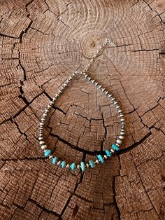 This exquisite choker features expertly crafted lustrous pearls and stunning turquoise, strung together by renowned Navajo artist Lucinda Sardo. Elevate any look with the elegant combination of these precious gems.