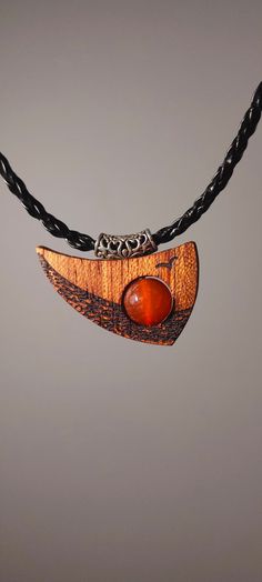 "Surprise your friend or enrich your outfit with unique handmade wooden necklace with a gemstone. It is made of African Bodo wood and charming Agate Stone. Buying this wooden pendant you will get a stone-talisman of strength and wellbeing for all the life. Sunset Ocean inspiration is what our Sunset Ocean pendant symbolises. This unique bodo wood pendant with its unusual shape immerses you in a world of nautical adventure and endless horizons. The agate stone in the center of the pendant, which rotates around its axis, represents the sun at sunset. Agate symbolises strength, harmony and poise, while the bodo tree symbolises resilience and the natural beauty of nature.  PENDANT SIZE:  26*36mm  NECKLACE LENGTH: 45 cm the width 3 mm \"Sunset Ocean\" is not just a piece of jewellery - it is a Bohemian Wood Necklace For Gift, Bohemian Wood Necklaces Perfect For Gifts, Bohemian Wood Necklace As Gift, Bohemian Wood Necklace Perfect As A Gift, Bohemian Natural Wood Necklaces As Gift, Bohemian Wooden Necklace For Gift, Bohemian Natural Wood Necklace As Gift, Gift Wooden Bead Necklaces In Natural Wood, Natural Wood Necklaces With Wooden Beads For Gift