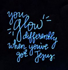 the words you glow differently when you've got jesus written in blue ink on a black background