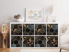 a white cabinet with gold and black designs on it