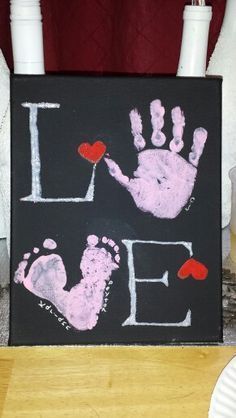 a hand and foot print painted on a canvas