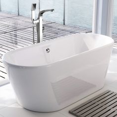 a white bath tub sitting on top of a bathroom floor