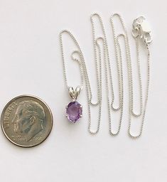 Genuine small oval amethyst measures 7x5mm (3/4 carat) and was handset in sterling silver. Sterling silver box chain is 18 inches long and can be switched out to a 16 inch chain upon request. Necklace is perfect for a child or the minimalist. Comes in a gift box Purple Gemstone Necklace With Oval Pendant, Purple Gemstone Oval Pendant Necklace, Oval Amethyst Birthstone Necklaces, Purple Oval Gemstone Necklace, Purple Birthstone Oval Pendant Jewelry, Purple Amethyst Oval Pendant Necklace, Purple Amethyst Oval Pendant Jewelry, Purple Oval Pendant Birthstone Jewelry, Oval Lavender Gemstone Necklace