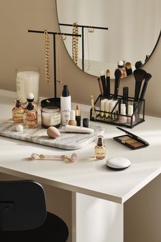 a vanity with makeup and other items on it