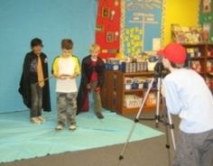 a group of children standing on top of a blue carpet