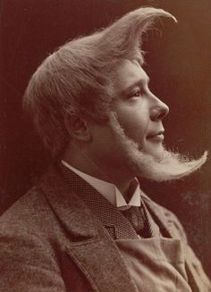 an old black and white photo of a man with a long beard wearing a suit