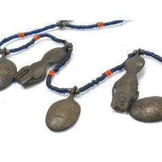 Naga Ancestor Necklace with 19th Century Bronze Heads and Figures Framing this magnificent Naga Ancestor/ "Head Hunter's" Bronze Charm Collection are Hand-wound Naga Heirloom Glass Beads, originally created in the late 19th century up until the mid 20th century in China, and made to resemble precious red coral, turquoise, lapis lazuli and golden amber. These richly colored beads were later traded among Naga people in Northern India and Burma. Because of their rarity and desirability, these "fore Ceremonial Beaded Pendant Jewelry, Vintage Ceremonial Jewelry With Polished Beads, Artisan Hand-strung Jewelry For Ceremonial Occasions, Antique Beaded Pendant Necklace, Antique Beaded Pendant Jewelry, Head Hunter, Hand Wound, Brass Pendants, Golden Amber