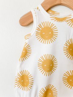 Your little will look super cool while staying cool in this bubble romper! So perfect for layering in cooler weather, and on it's own for hot summer days! This romper is sewn up in a super cute sunshine print. Pair it with the matching shorts and peplum tank for a sibling set! This stylish bodysuit features cotton produced in the USA that is certified organic by global organic textile standards so you can feel good about dressing your baby in it! We serge all seams for added durability and stren Summer Bubble Romper For Spring Playdate, Summer Bubble Romper For Playdate In Spring, Summer Cotton Onesie, Cute Summer Cotton Onesie, Summer Bubble Romper For Playtime In Spring, Playful Spring Onesie For Playwear, Fun Summer Playwear Onesie, Summer Cotton Onesie For Playwear, Fun Cotton Bodysuit For Spring