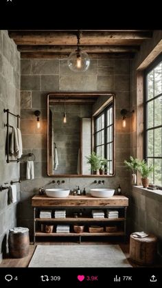 a bathroom with two sinks and a large mirror above the sink in front of a window