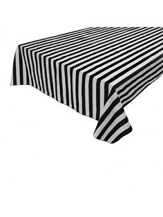 a black and white image of a table with a striped cloth on it's top