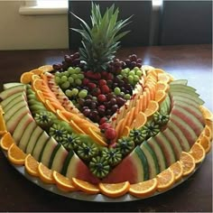 a fruit platter is arranged in the shape of a heart