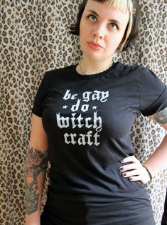 Discover your true power with this original Be Gay Do Witch Craft Tee. It's crafted of super soft cotton and adorned with enchanting words of queer pride, empowering you to be bold and embrace the witch within. Unleash the magic! Each garment is hand screen printed by yours truly! Super soft unisex black tee, made with 100% combed and ring-spun cotton. Shirts are manufactured in ethical WRAP* certified factories. Unisex sizes XS-4XL.*WRAP (Worldwide Responsible Accredited Production) is a global Cotton Slogan Tops For Alternative Fashion, Cotton Tops With Slogan For Alternative Fashion, Black Pride Screen Print Top, Black Screen Print Tops For Pride, Black Screen Print Top For Pride, Witchy Cotton Tops With Letter Print, Witchy Cotton Crew Neck Tops, Cotton Tops With Text Print For Alternative Fashion, Cotton Screen Print Tops For Pride