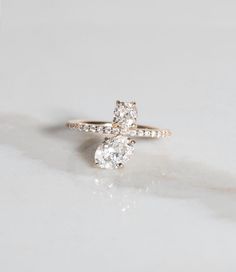 an engagement ring with two pear shaped diamonds