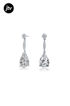 A large solitaire of clear pear Cubic Zirconia sits at the bottom of these drop earrings. These earrings also features a trail of small clear round Cubic Zirconia that is connected to the drop stone and the flower design round Cubic Zirconia post. These are set in Rhodium Plated over Sterling Silver and secured with a butterfly clasp.
measurement 27mm Teardrop Diamond Cut Bridal Earrings, White Pear-shaped Teardrop Earrings With Prong Setting, White Diamond-cut Teardrop Earrings, White Diamond Cut Teardrop Earrings, Diamond Cut Drop Bridal Earrings, Classic Pear-shaped Cubic Zirconia Teardrop Earrings, White Cubic Zirconia Teardrop Earrings With Prong Setting, Teardrop Crystal Earrings With Prong Setting, Classic Teardrop Cubic Zirconia Earrings