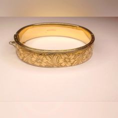 Floral Dunn Bros. G.F On Sterling Hinged Bangle Bracelet Stamped/Engraved; 1/20 Gold Filled On Sterling Bangle Bracelet That Has An Ornate Floral Design Around The Entire Bangle. Width: 1/4" External Dimensions: 7 3/4" Length Fits Up To A 7" Wrist 2mm Thickness Slide In Clasp Closes Securely. Fabulous Condition, Well Maintained, No Brassing Or Fading. Classic Etched Gold Bracelet For Formal Occasions, Formal Engraved Gold Bracelets, Formal Gold Engraved Bracelets, Engraved Gold Bangle Bracelet For Formal Occasions, Elegant Etched Yellow Gold Cuff Bracelet, Formal Engraved Gold Bangle Bracelet, Formal Engraved Bangle Bracelets, Engraved Bangle For Formal Occasions, Elegant Etched Yellow Gold Bangle