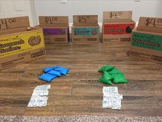 several boxes are sitting on the floor with blue and green napkins in front of them