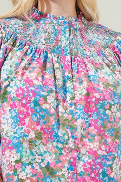 It's impossible not to love the way you'll look in the Avery Blossom Smocked Mock Neck Top! An enchanting ditsy floral print overlays across this button up top with short puff sleeves. Its smocked mock neck gives it an extra touch of cuteness. Wear it tucked into some shorts or jeans with heels for a nice look!- Smocked- Button front- Lightweight- Puffed sleeves- Color: Dusty PinkSize + Fit - Model is 5'9" and wearing size 2X- Measurements taken from size 2X - Chest: 29 1/2"- Length: 29" Fabric Pink Floral Smocked Top For Spring, Spring Multicolor Smocked Top With Smocked Back, Pink Top With Smocked Back For Spring, Summer Multicolor Smocked Top With Smocked Cuffs, Multicolor Smocked Top With Smocked Cuffs For Summer, Spring Pink Smock Top, Multicolor Smocked Top For Spring, Summer Multicolor Smocked Top With Floral Print, Spring Floral Print Smocked Top