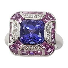 Tanzanite 3.36 carats with Pink sapphire 2.61 carats and Diamond 0.14 carat Ring set in 18 Karat White Gold Settings Width: 1.6 cm Length: 1.6 cm Ring Size: 53 Total Weight: 10.61 grams "We first opened doors in 1980 when it was then situated in the vicinity of the Victory Monument; a small and modest storefront with a couple of counters. From its humble beginnings to where it stands today, our company has proven its abilities as a jeweler. Since the beginning, we have been supplying fine qualit Luxury Multi-stone Sapphire Gemstones, Luxury Purple Rings Gia Certified, Luxury Purple Gia Certified Rings, Luxury Sapphire Gemstones With Round Cut, Gia Certified Pink Sapphire Rings For Formal Occasions, Luxury Pink Sapphire Ring For Formal Occasions, Luxury Tanzanite Diamond Ring Gia Certified, Luxury Brilliant Cut Sapphire Gemstones, Luxury Gia Certified Tanzanite Diamond Ring