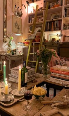 a dining room table with candles and plates on it