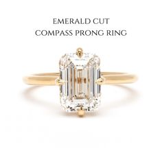 the emerald cut compass prong ring is shown in yellow gold and features an oval diamond