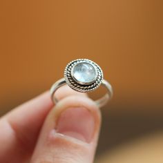 Playful and fun new western-style ring in Gorgeous Aquamarine and sterling silver. This is a perfect dainty southwestern ring with a twist - a double twist that is! Two .925 Sterling Silver graduated twist wires accent a 6mm Aquamarine cabochon. High-grade Blue Aquamarine with a perfectly detailed, sterling silver setting. Super cute blue aquamarine ring!! Set in .925 sterling silver -- oxidized and burnished bezel and wire. Simple, elegant, and perfect. This lovely little ring is created using Silversmith Rings, Blue Aquamarine Ring, Tourmaline Bracelet, Crazy Lace Agate, Aquamarine Rings, Agate Necklace, Quartz Pendant, Agate Pendant, Quartz Necklace