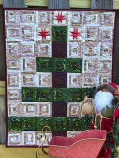 a quilted christmas tree with santa's sleigh in the foreground