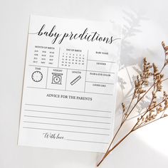 a baby dedication card next to some dried flowers on a white surface with the words, baby preparations written in cursive writing