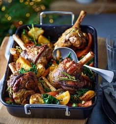 a roasting pan filled with meat and vegetables