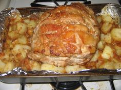 meat and potatoes in foil on top of the stove