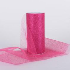 a roll of pink glitter ribbon on a white background