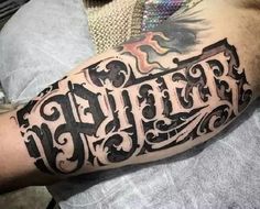 a man with a tattoo on his arm has the word faith written in black ink