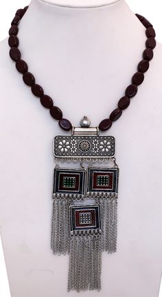 Easy slip on neck wear for a festive and formal look. This is a hand engraved oxidized silver pendant necklace with deep red wine colored beads that define this modern look tribal jewelry. It will add a touch or medieval royal charm to add outfit. Traditional Brown Jewelry For Festive Occasion, Traditional Red Necklace With Oxidized Finish, Festive Silver Temple Jewelry Beads, Traditional Metal Beaded Necklaces With Silver Beads, Traditional Brown Beaded Chain Jewelry, Traditional Beaded Necklaces With Silver Beads, Traditional Metal Necklace With Beaded Chain, Festive Silver Pendant Beaded Necklaces, Festive Silver Beaded Necklaces With Pendant