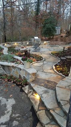 an outdoor patio with stone steps and lights