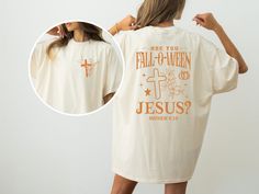 Get ready for the perfect blend of faith and fall with our "Falloween Jesus" Christian sweatshirt! This cozy and stylish retro Halloween shirt is perfect for anyone who loves to celebrate the season while staying true to their beliefs. Featuring a fun and unique "Are You Fall-O-Ween Jesus?" design, this shirt is ideal for church gatherings, casual fall outings, or as a thoughtful gift for a loved one. Crafted for both comfort and style, our Bible Matthew Shirt is made from high-quality, soft material that feels great all day long. With front and back design options, it's a versatile piece for your fall wardrobe. Whether you're looking for a cute, thankful shirt for autumn or a funny Jesus shirt that spreads a positive message, this retro fall religious shirt is perfect for you. Key Feature Halloween Christian Shirt, Jesus Halloween Shirt, Are You Fall O Ween Jesus, Bible Matthew, Fall Outings, Jesus Design, Fall O, Thankful Shirt, Christian Friends