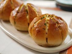 three hot cross buns on a white plate