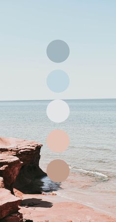 an image of the ocean with circles floating in the air above it and on the beach